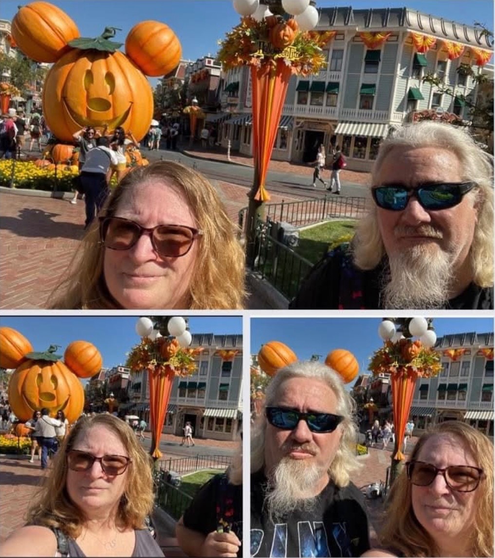 Lawrence and his wife at Disneyland Main Street during Halloween Time with a Mickey Mouse jack-o-lantern pumpkin