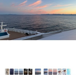 Alaska sunrise from the cruise ship deck — pink and orange clouds over calm ocean and a distant coastline